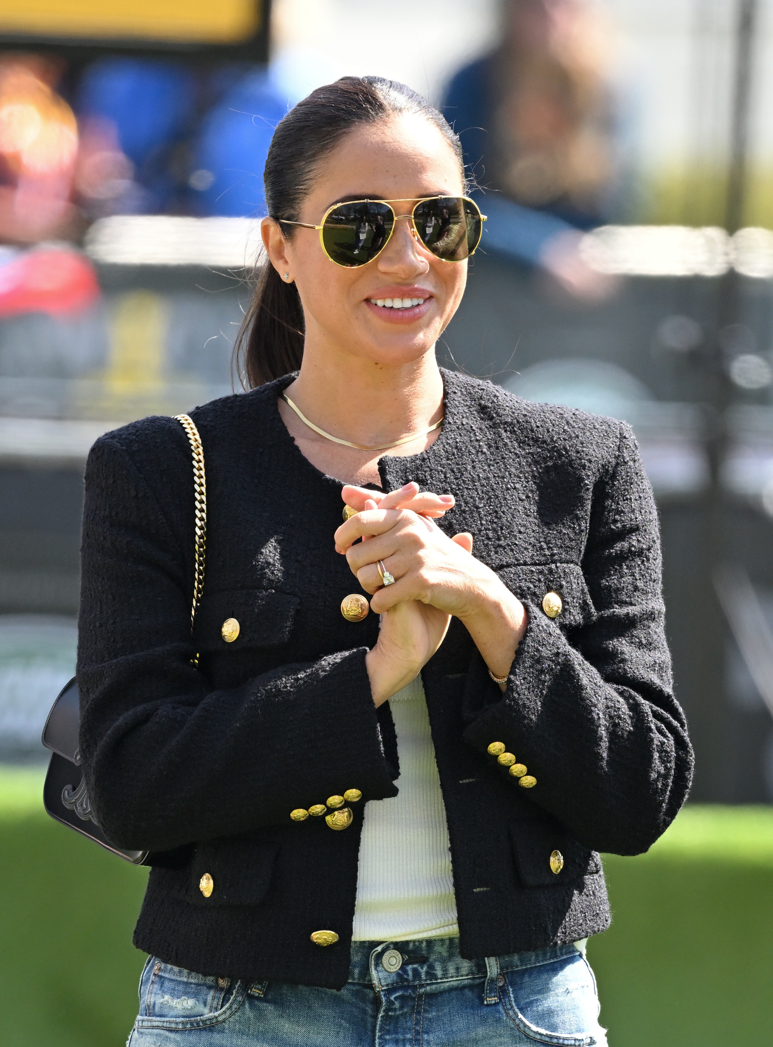 Meghan wearing sunglasses and dressed in jeans