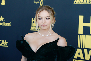 Sydney Sweeney wears a black strapless dress with a diamond necklace and her hair in an updo.