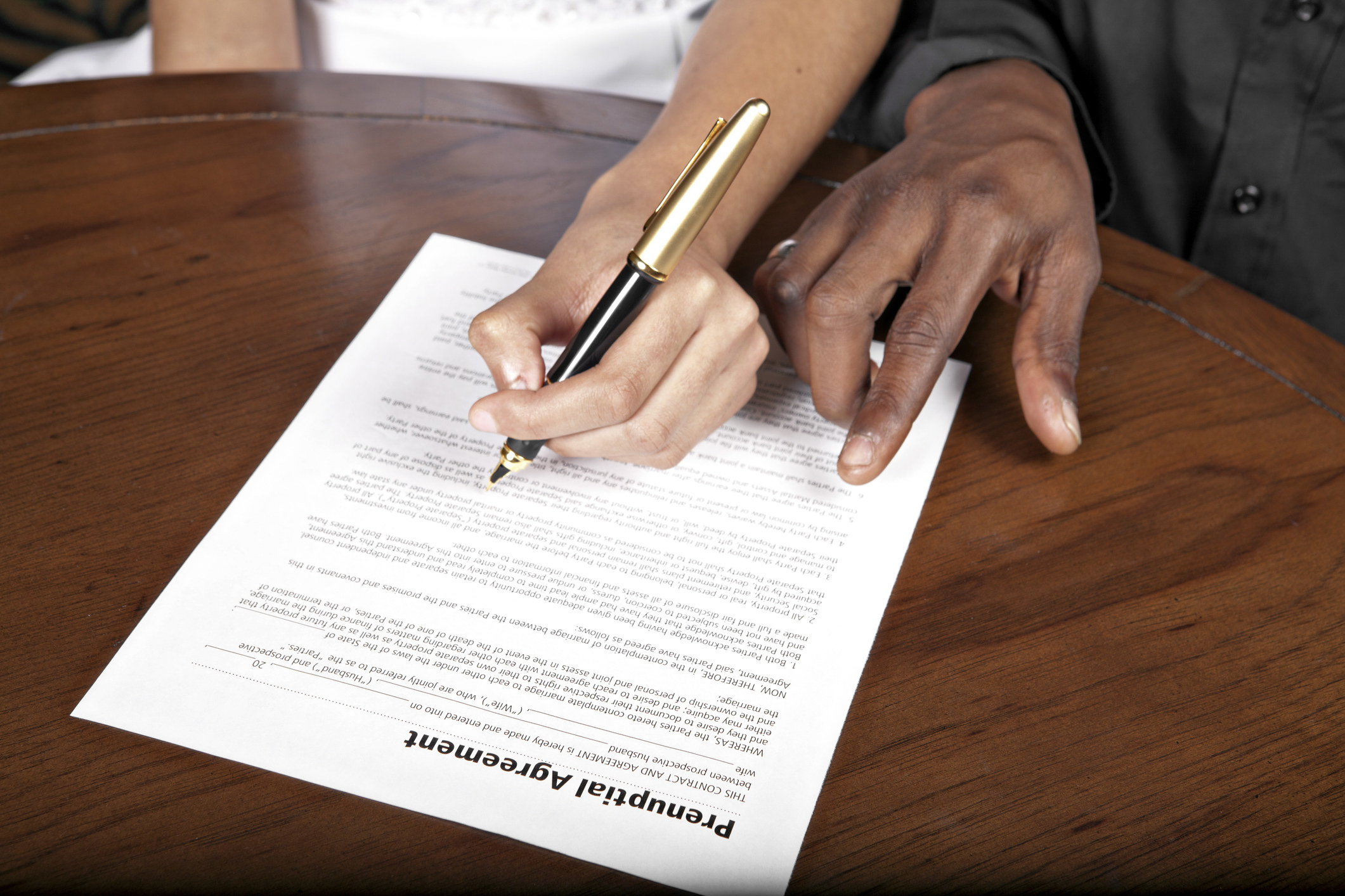 people signing a prenuptial agreement
