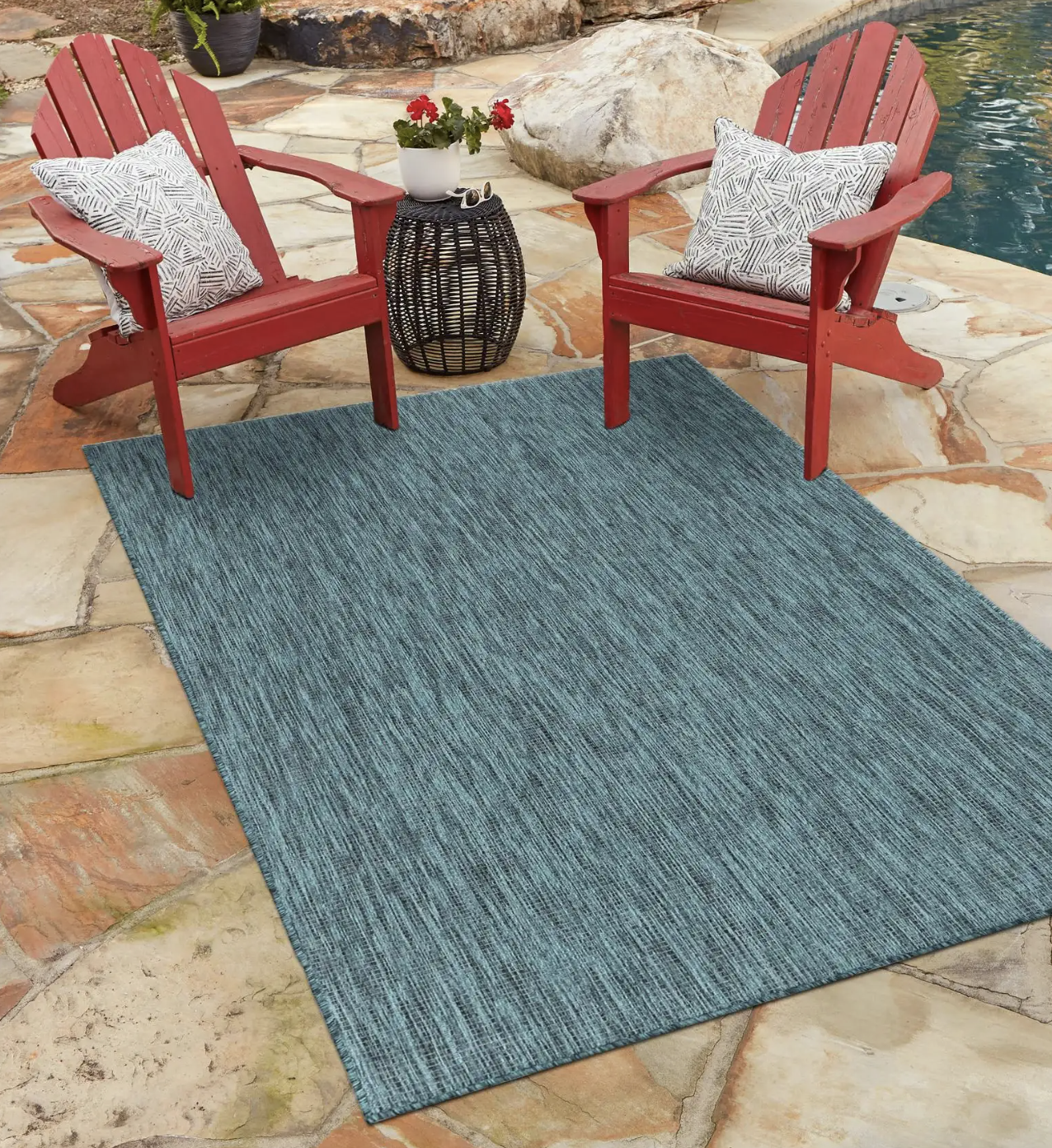 An outdoor rug is shown by a pool