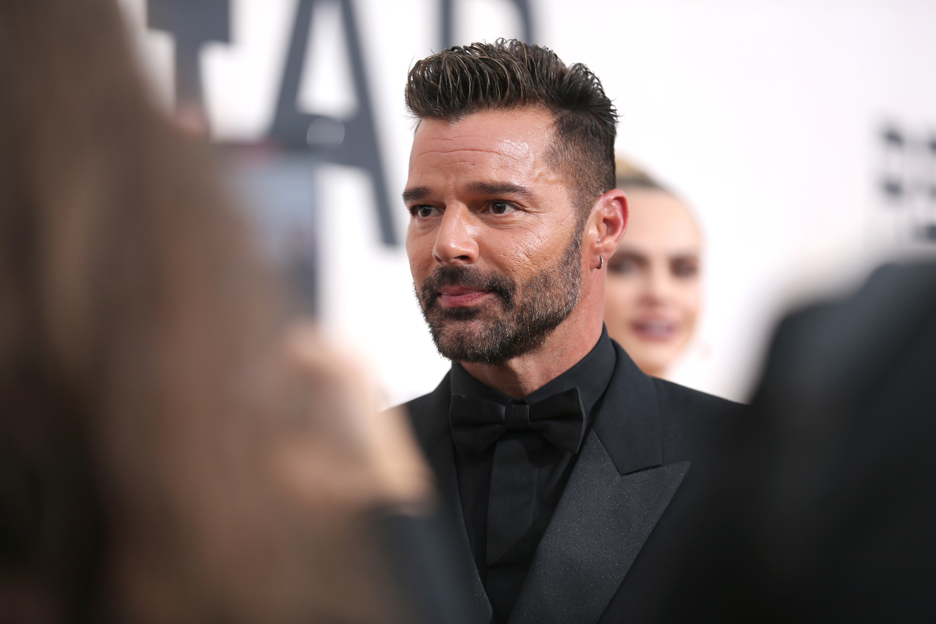 Ricky Martin looks away from the camera
