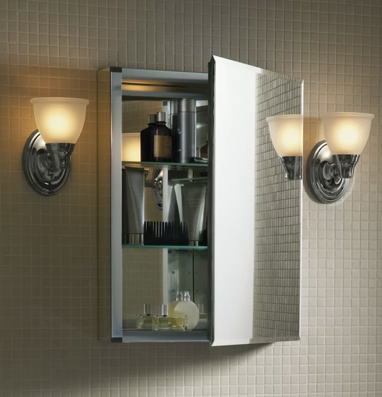 The mirrored cabinet installed in bathroom wall with door propped open
