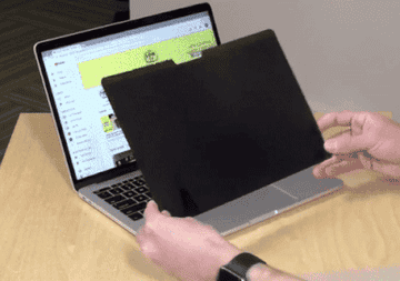 person putting the screen on their macbook