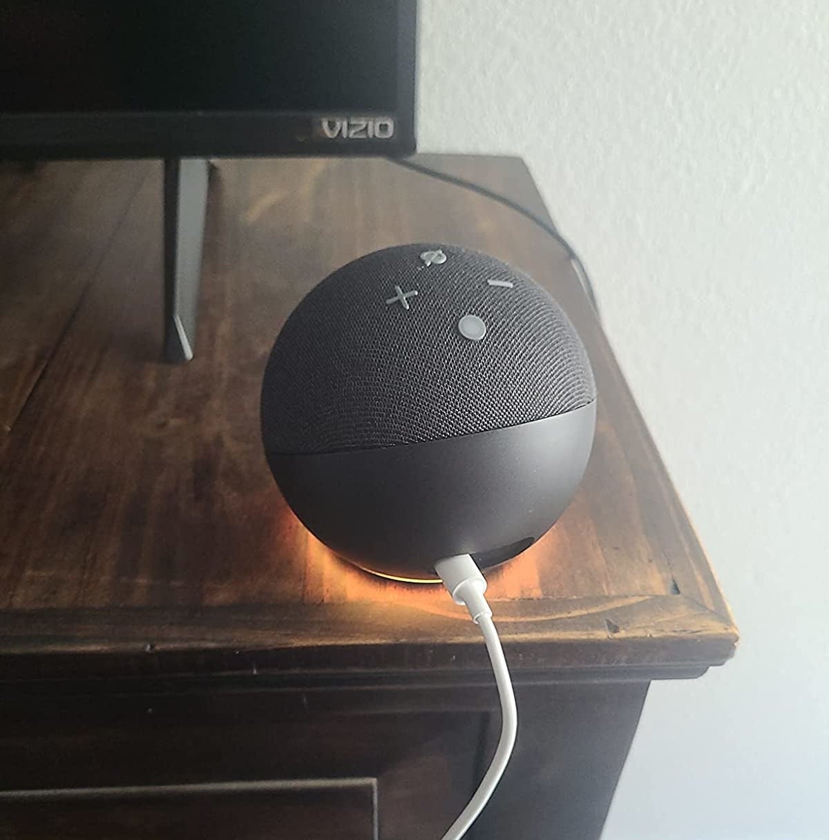 reviewer&#x27;s echo dot speaker in black on a dresser