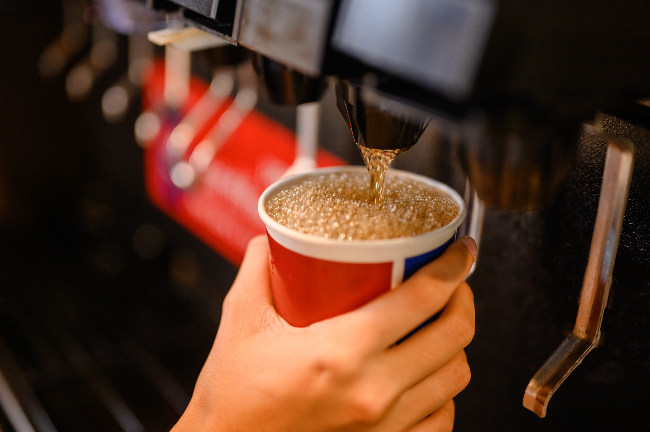 A person using a drink dispenser