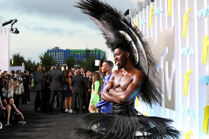 Lil Nas X at the VMAs in a feathered skirt and matching wings headpiece