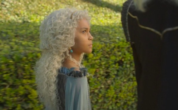 Laena looks up at Viserys while walking through the gardens