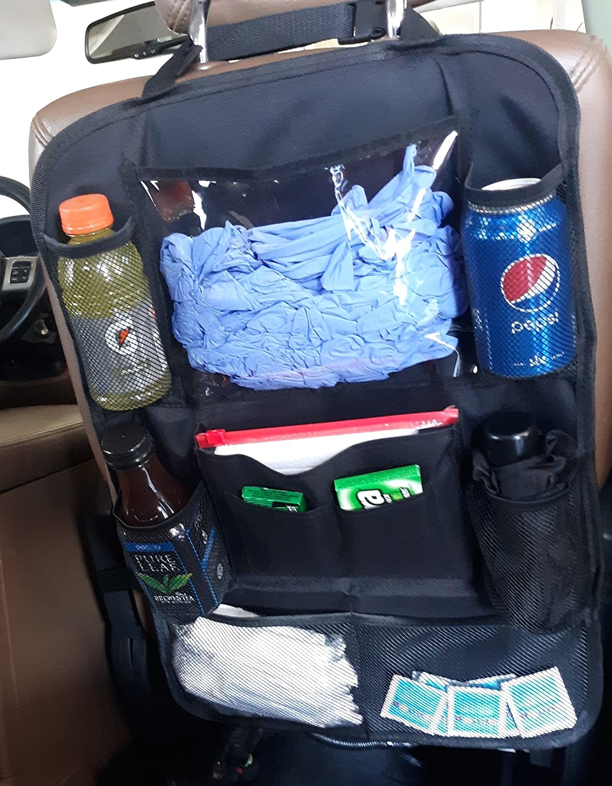Reviewer image of backseat organizer filled with drinks, disposable gloves and other items