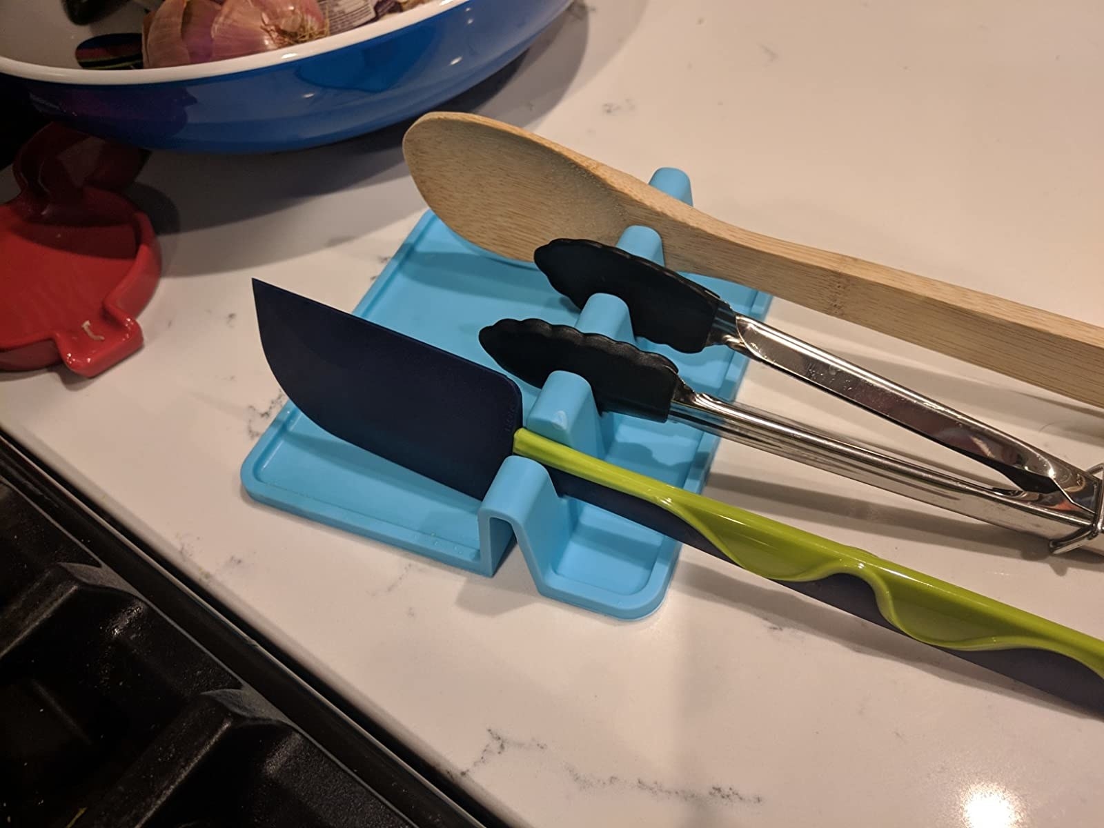 Reviewer image of blue utensil rest with three utensils in it