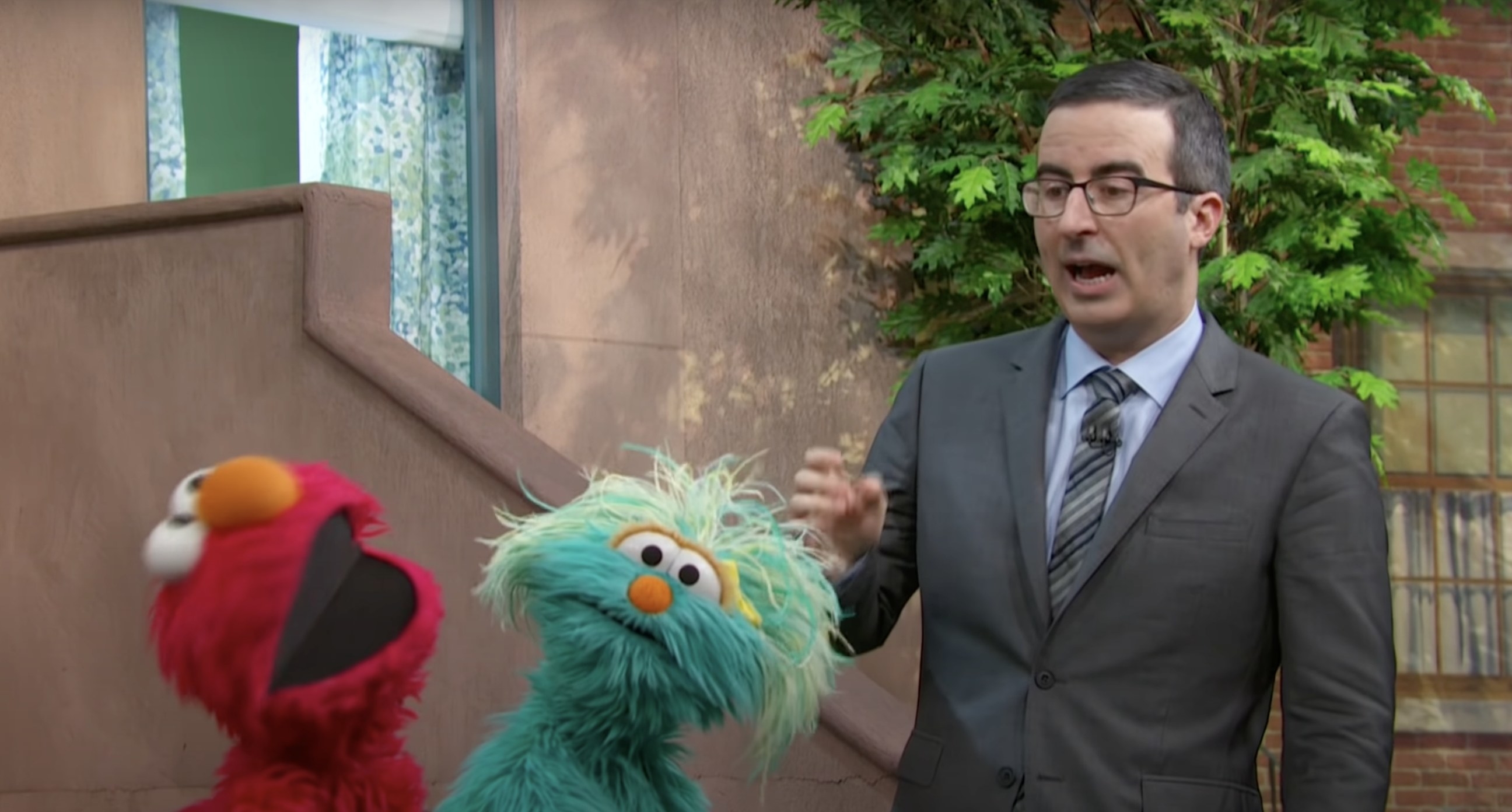 John Oliver talking to two muppets
