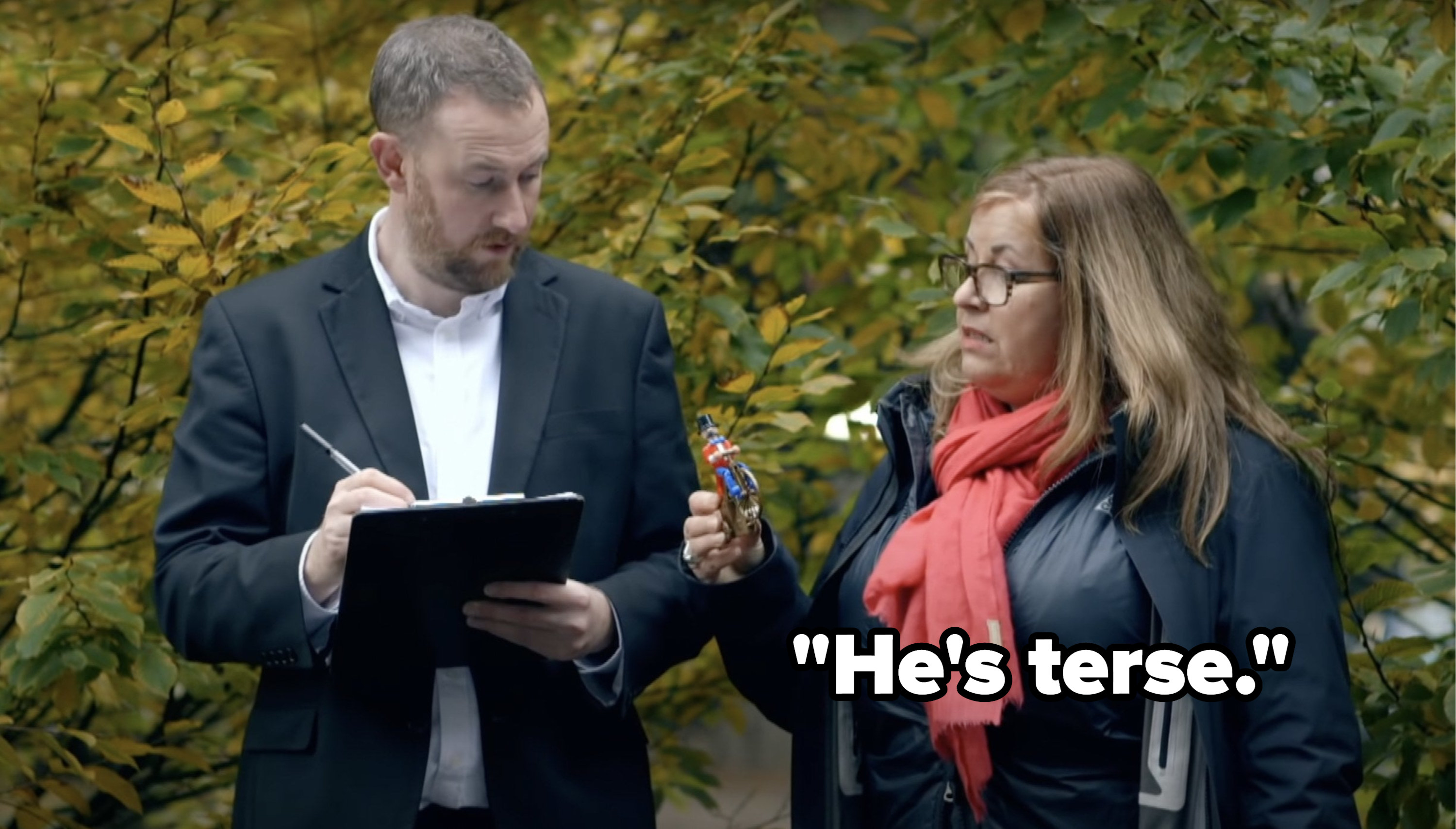 While she and Alex Horne look at a small toy, Liza Tarbuck says, Hes terse