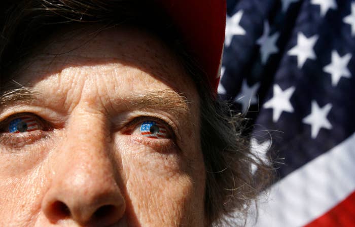 Closeup of someone&#x27;s eyes with the American flag in the background