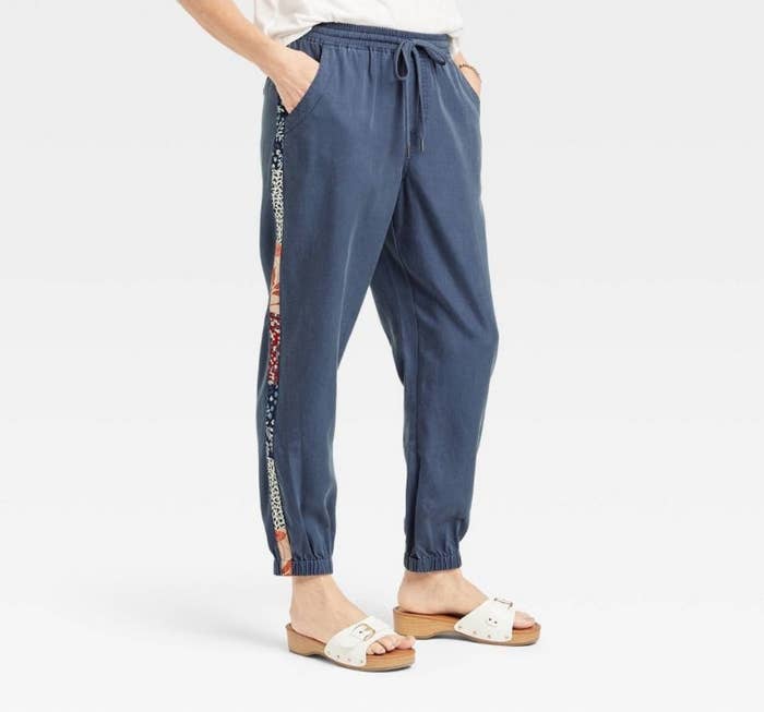A model wearing a pair of navy joggers