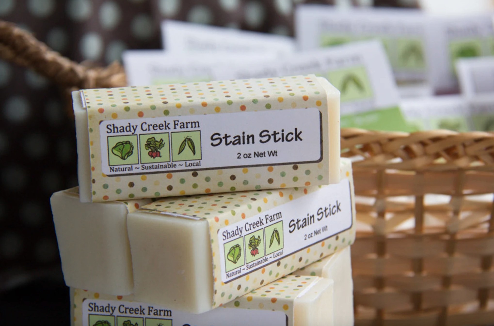 a stack of the white stain sticks with cream polka dotted packaging