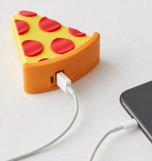 a pizza-shaped power bank charging a device