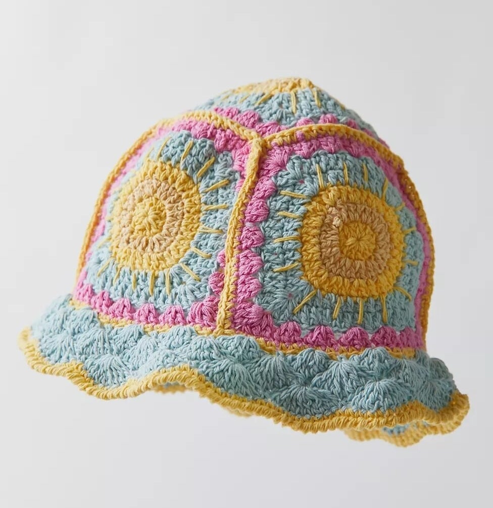 The crochet bucket hat against a plain background