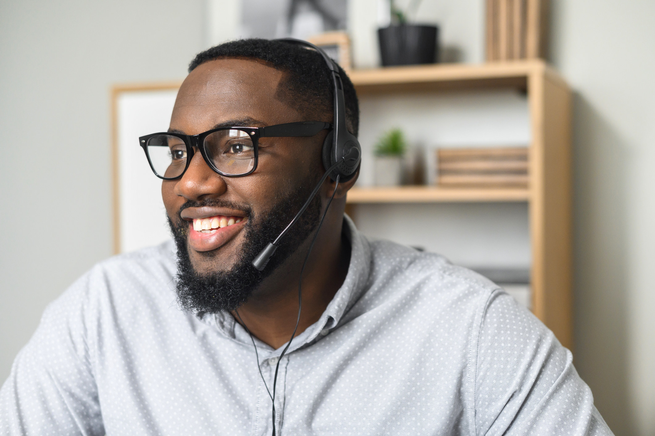 a man smiling and wearing a headset