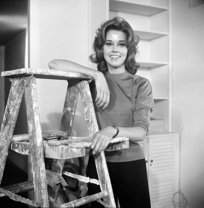 A young Jane smiles with her arm on top of a ladder