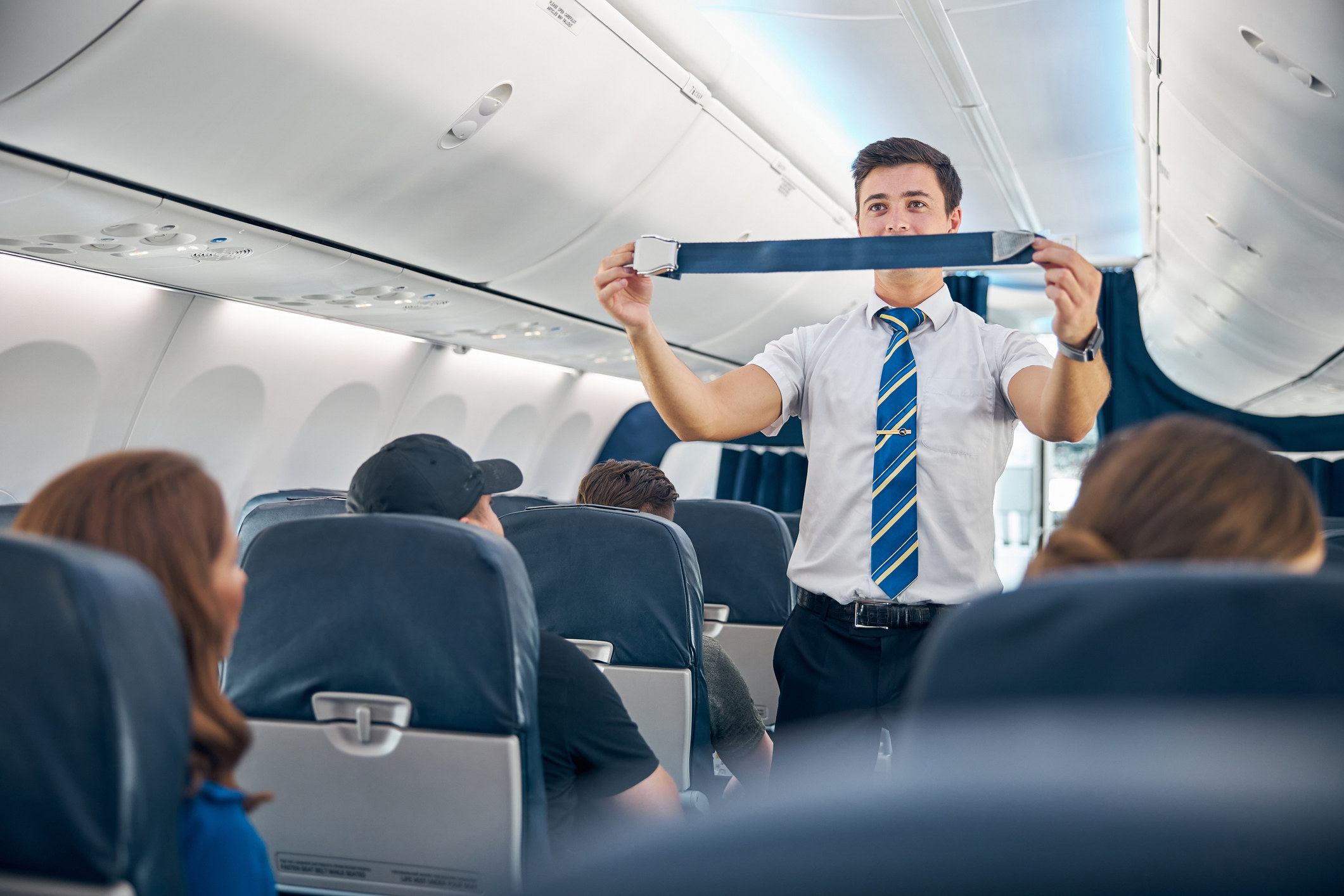 flight attendant showing a seat belt
