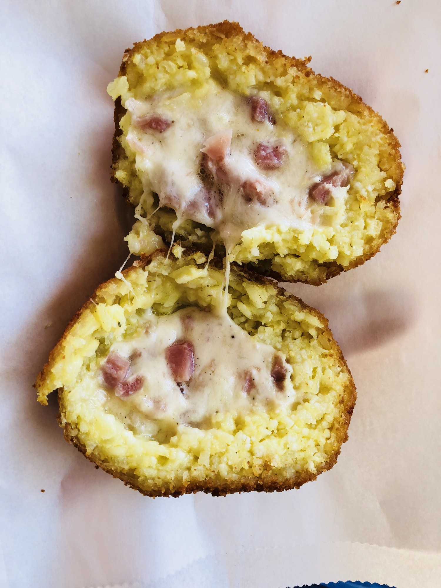 A fried rice ball stuffed with cheese and ham.