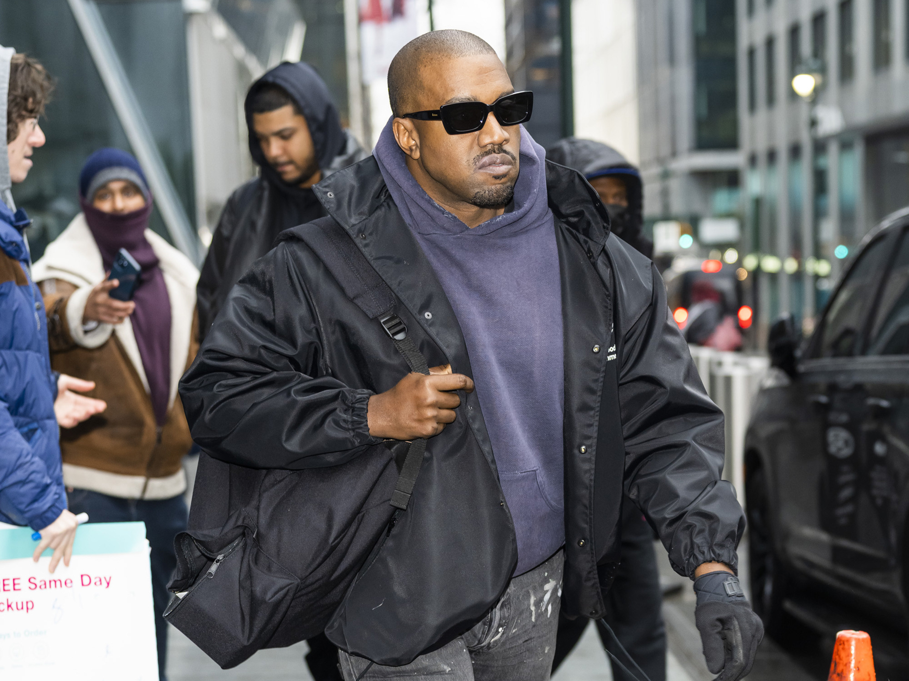 Kanye West walking in a crowded street