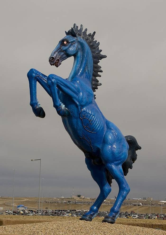 huge sculpture of a blue horse on hind legs