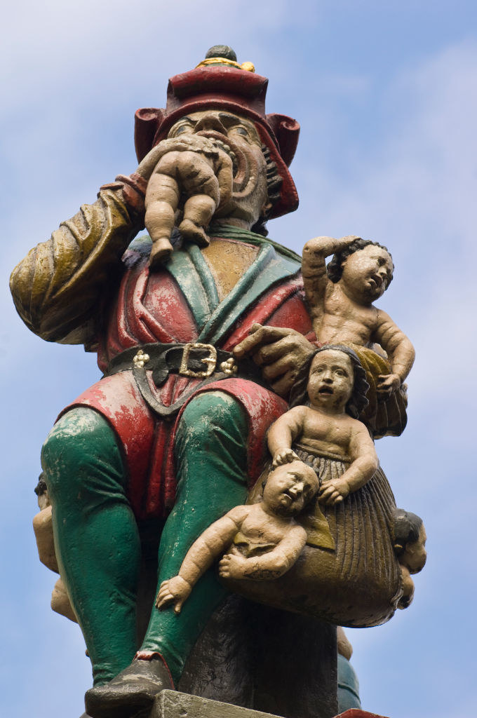 sculpture of giant eating babies