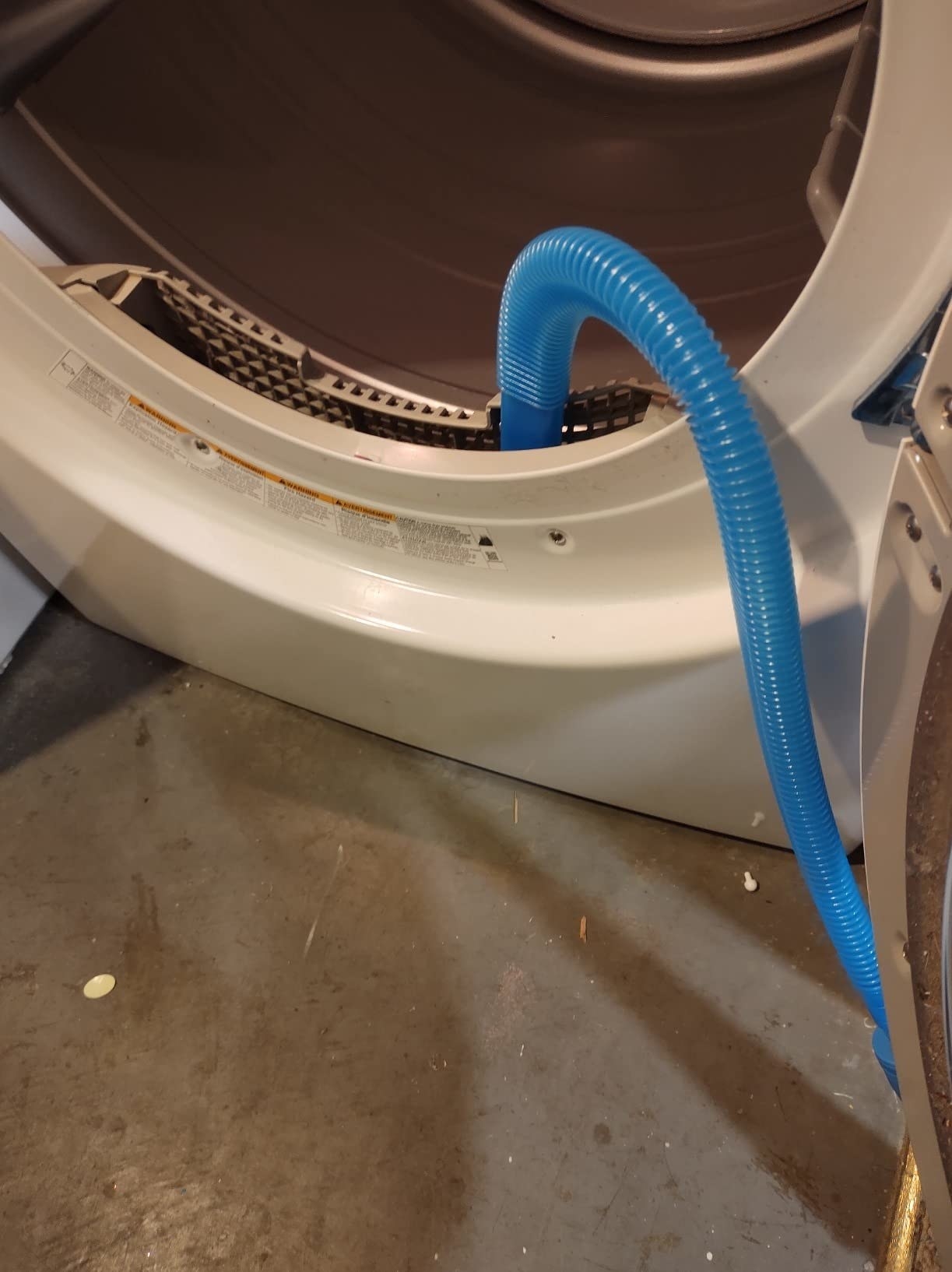 a reviewer photo of the blue vacuum tube in the lint trap of a dryer