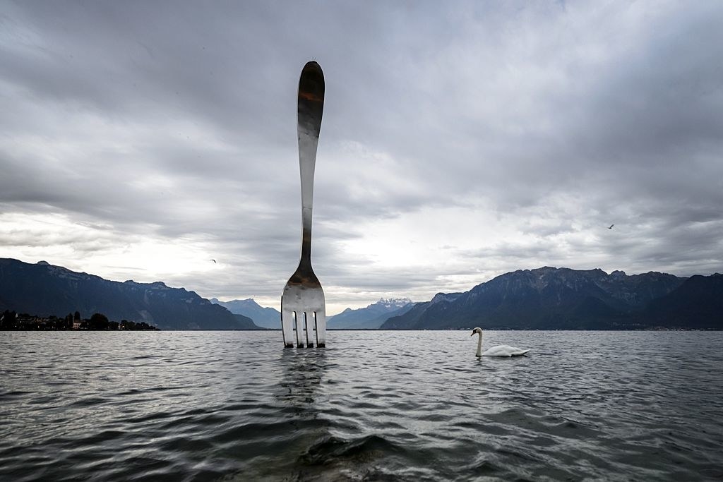 big fork sculpture in an ocean