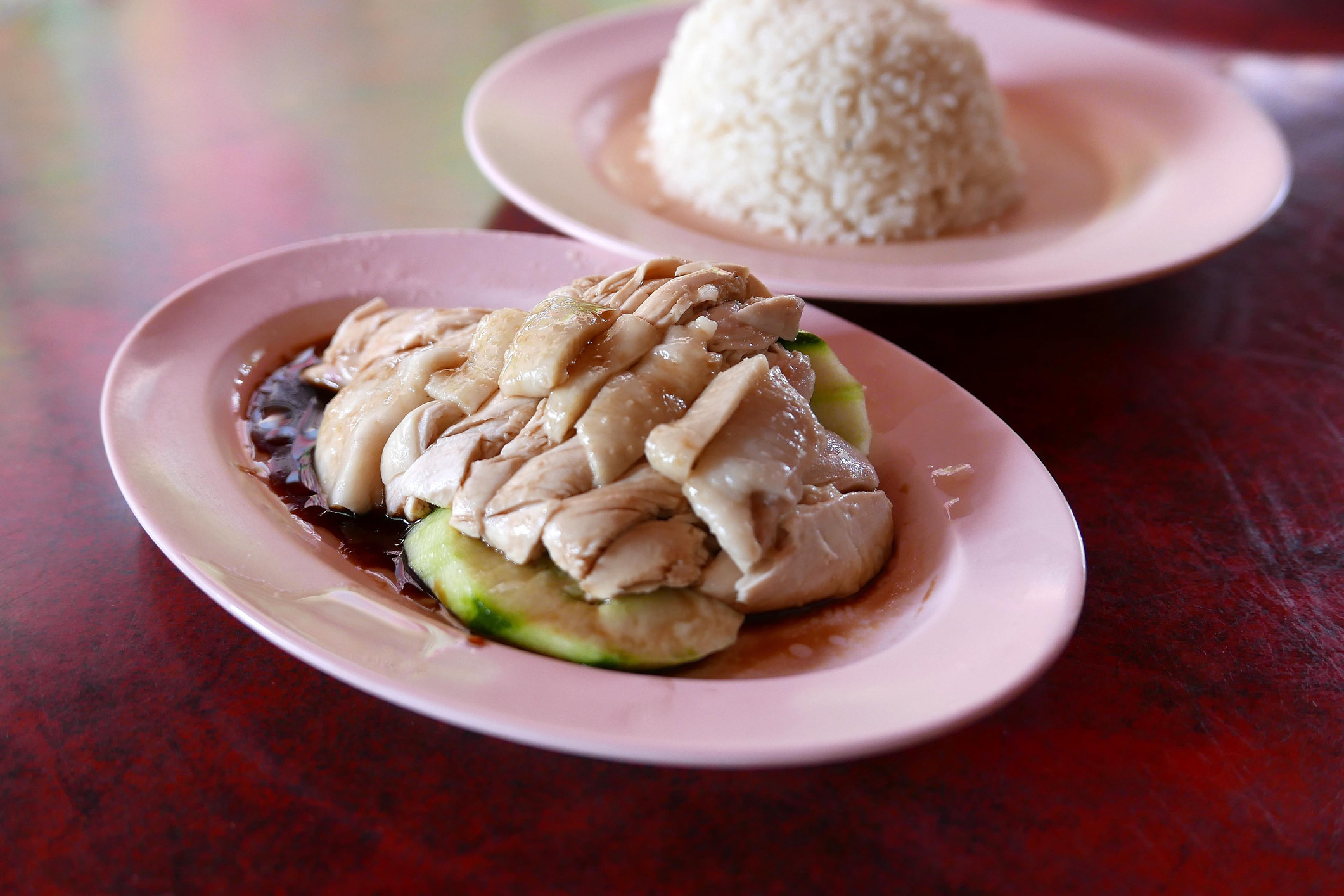 Hainanese chicken and rice on a table.