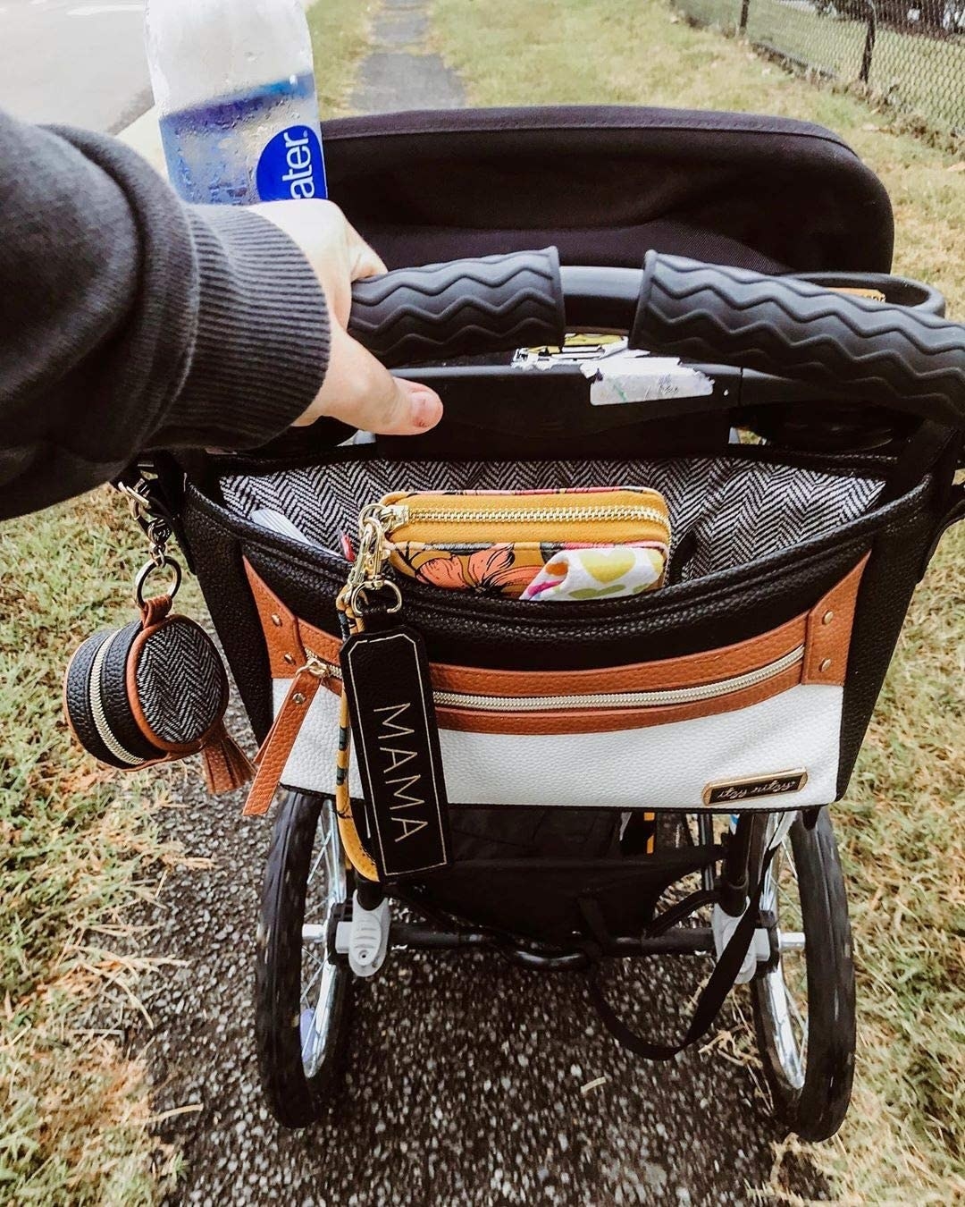 A person pushing a stroller with the bag on it