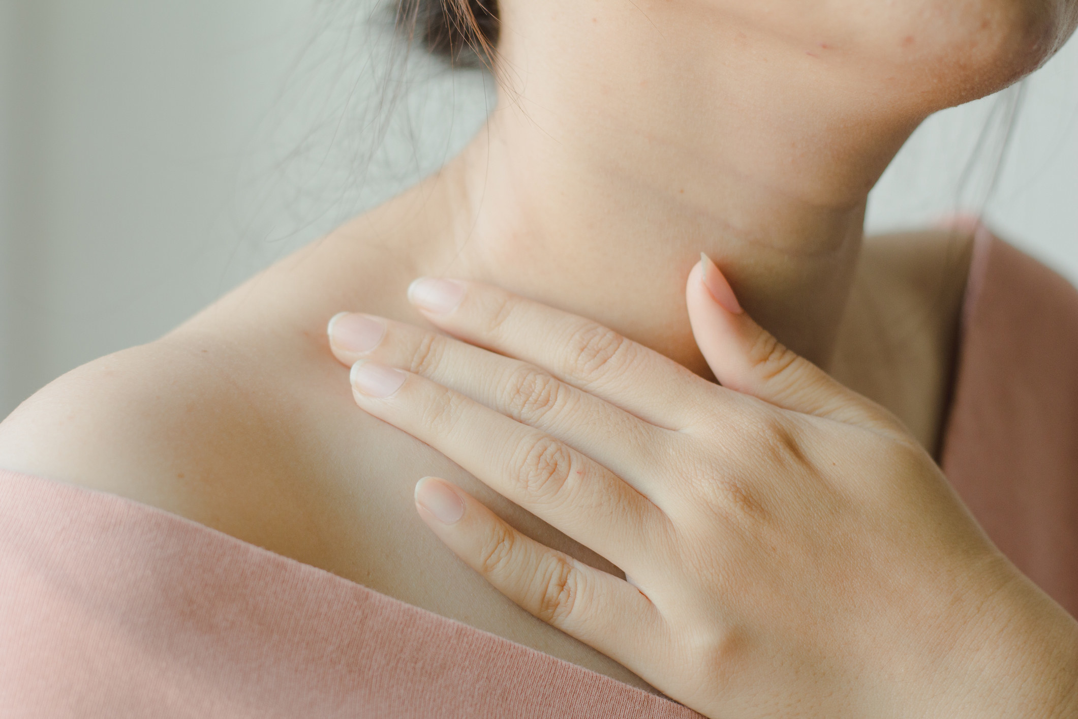Close-up of a woman touching her neck