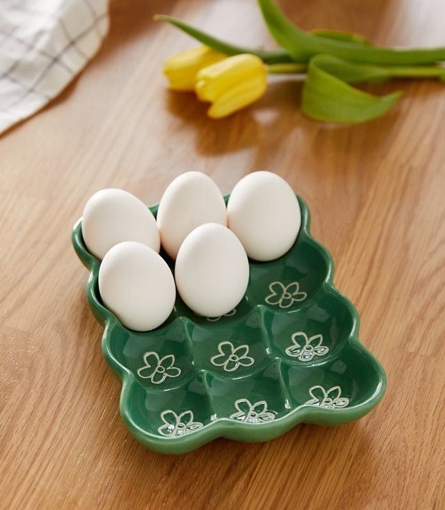 a ceramic egg tray that holds twelve eggs