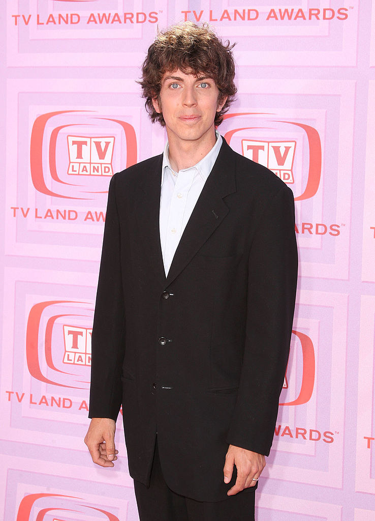 Taran as an adult in a suit on the red carpet