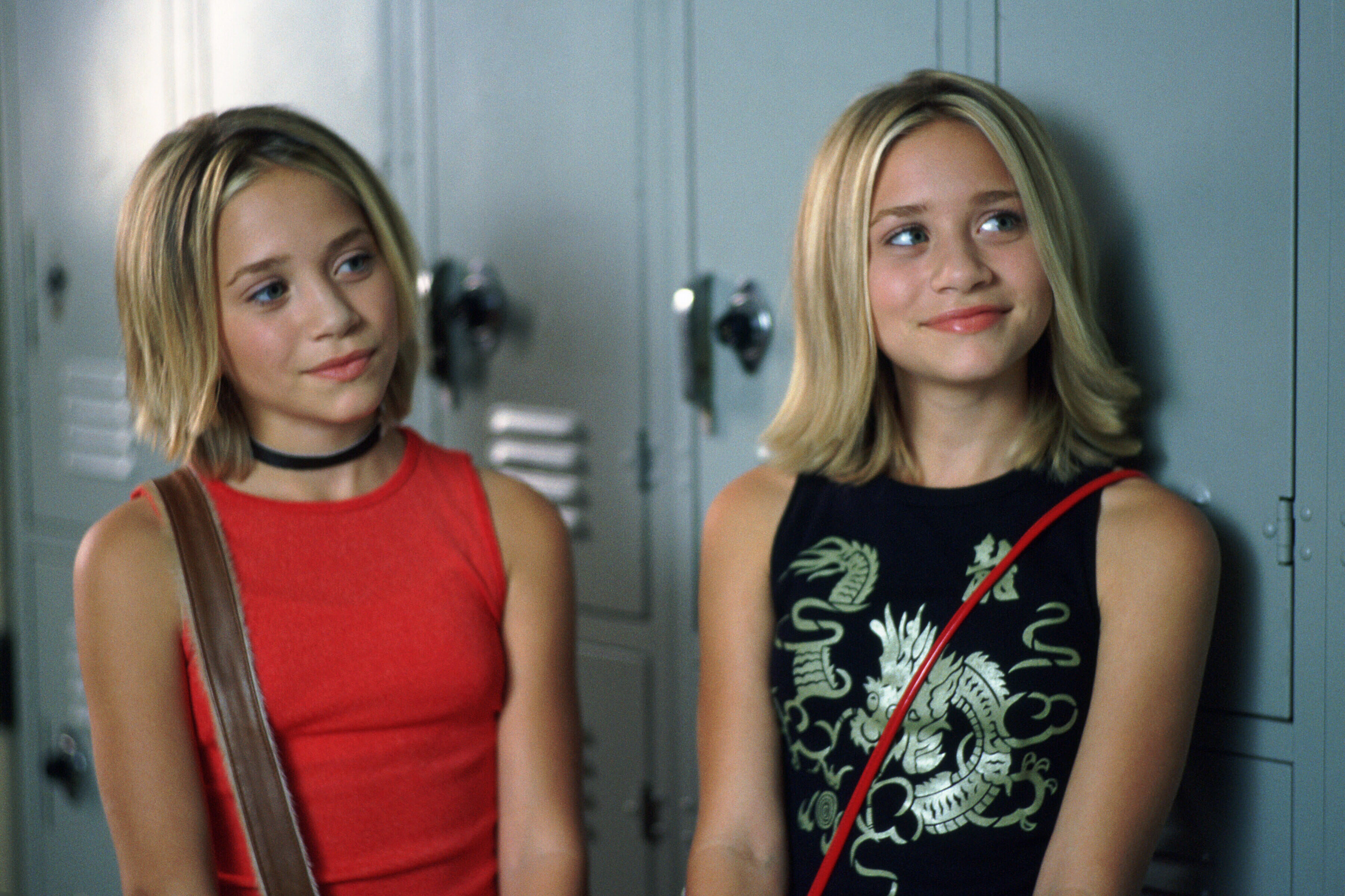 The Olsen sisters are young girls standing in front of school lockers