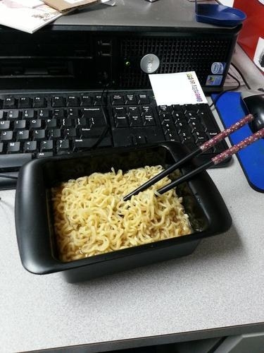 A reviewer&#x27;s cooked noodles in the maker, which is black and rectangular and can also be used as a bowl