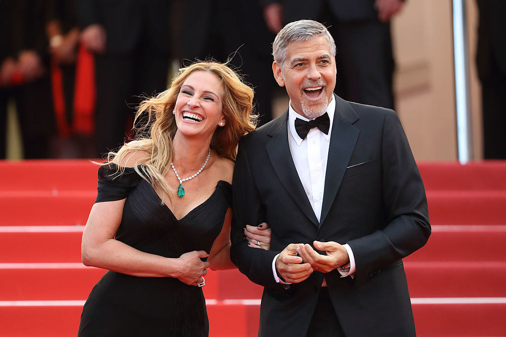 Julia and George on the red carpet laughing
