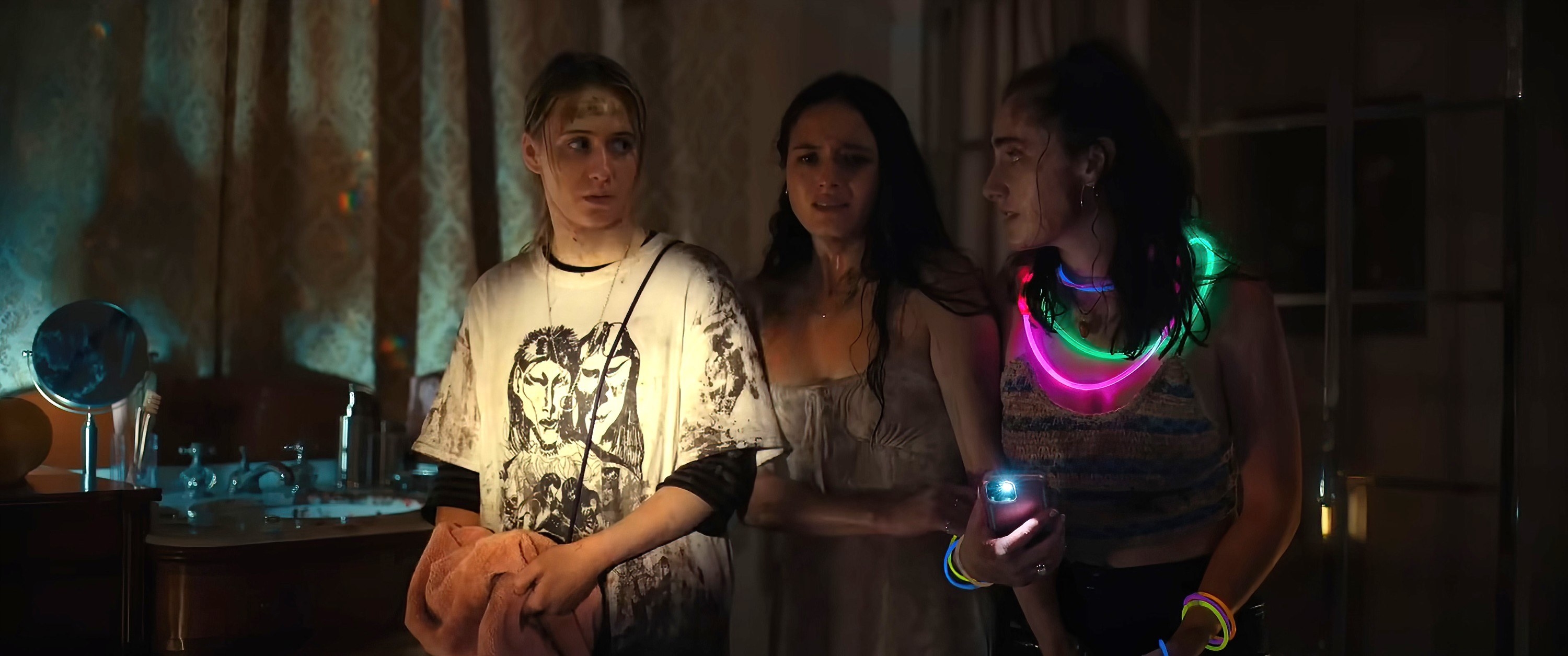 Three of the girls walking in a dark room
