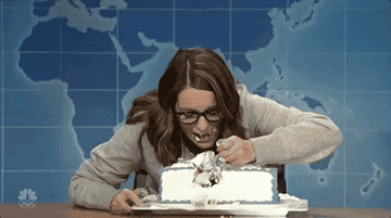 A woman stuffing her face with cake