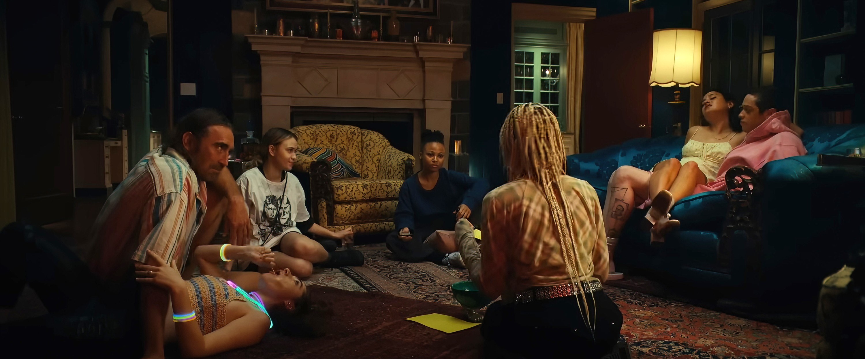 The group sitting in a circle on the floor and on sofas