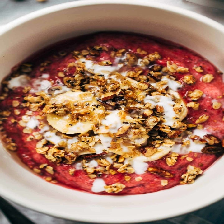 A raspberry breakfast bowl topped with granola.