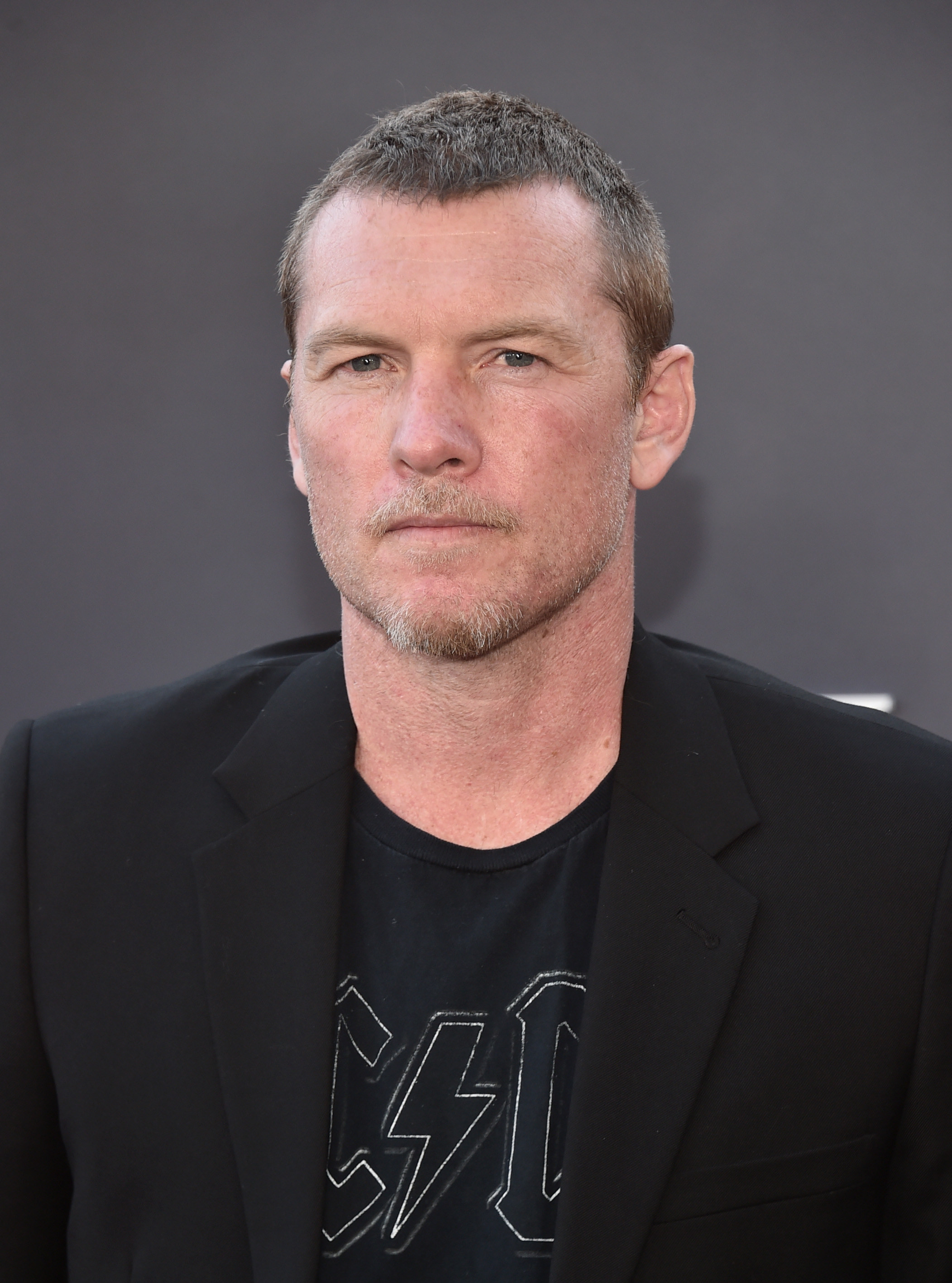 Sam Worthington poses at the &quot;Under The Banner Of Heaven&quot; premiere on April 20, 2022