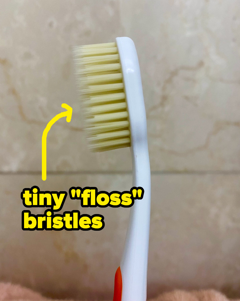 A toothbrush with two layers of bristles, one lengthy and thin and one shorter and thicker 