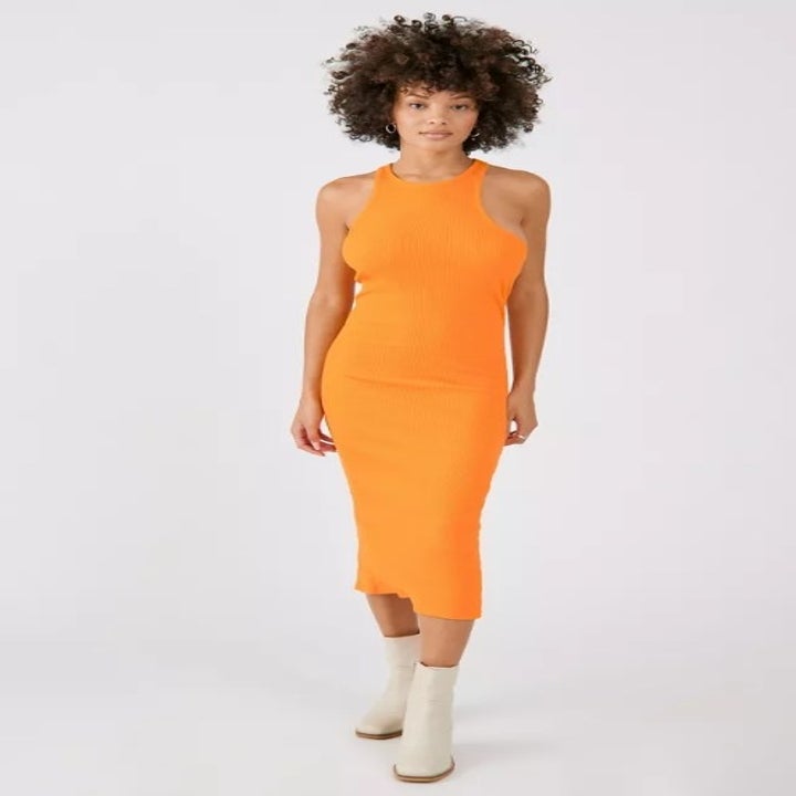 A model wearing the yellow asymmetrical midi dress