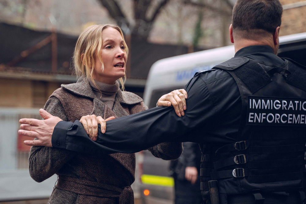 Joanne Froggatt tries to push past a police officer