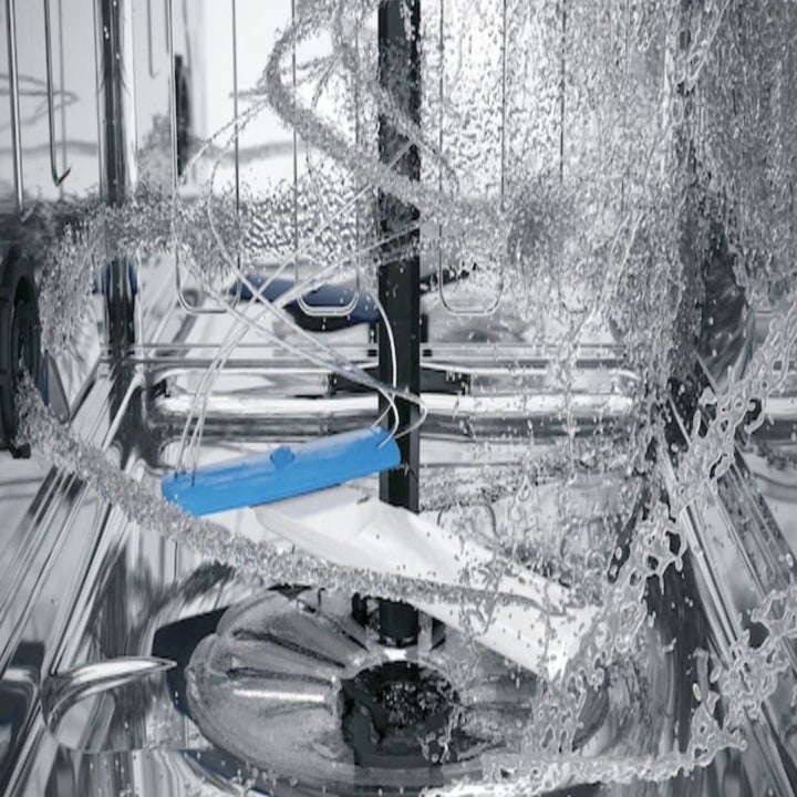 Close-up of the dishwasher spray and blade in action