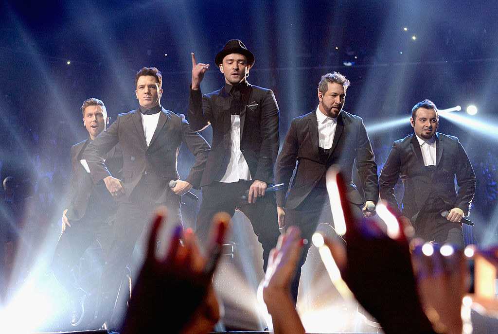 All five members of NSYNC perform on stage together at the VMAs