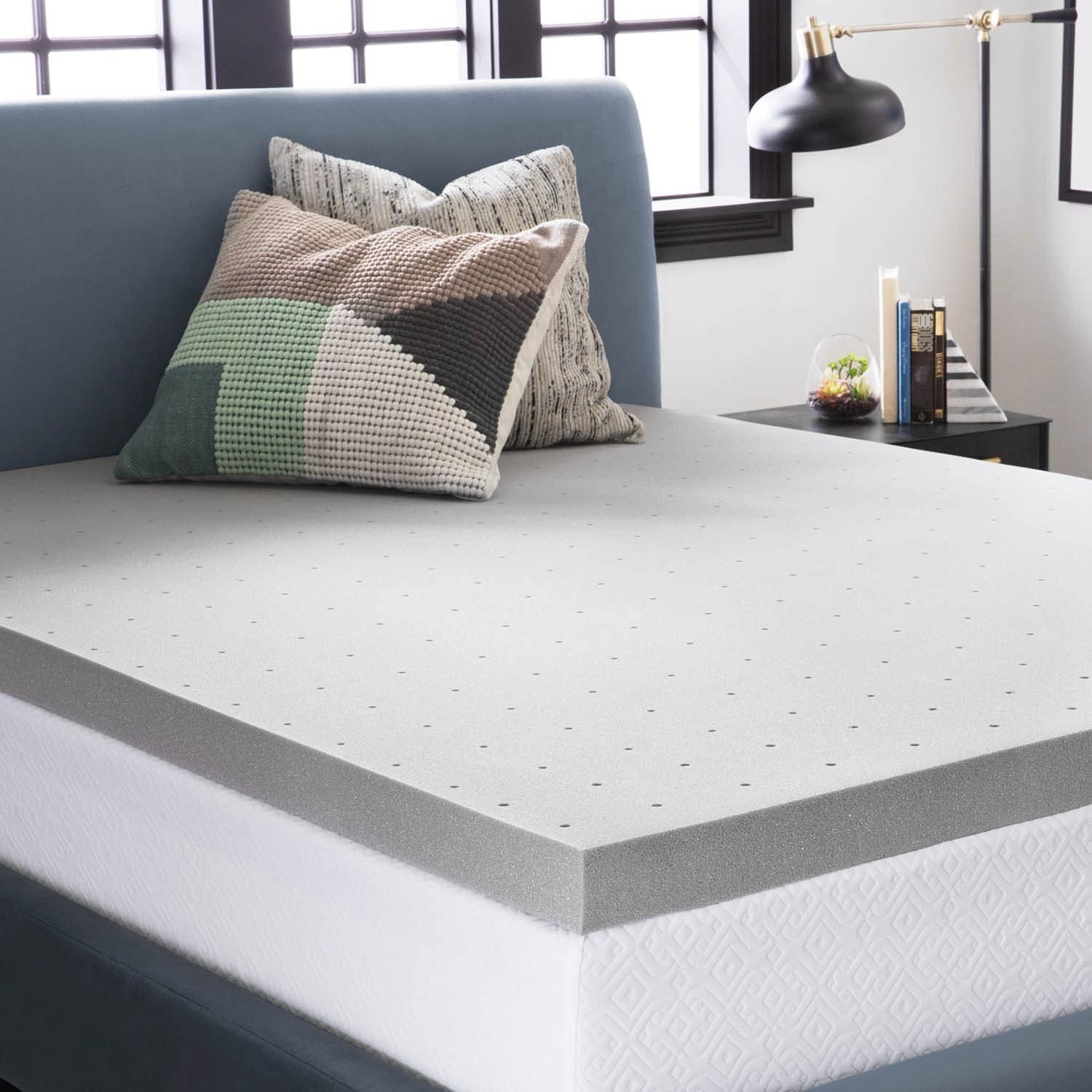 a memory foam mattress topper on a mattress