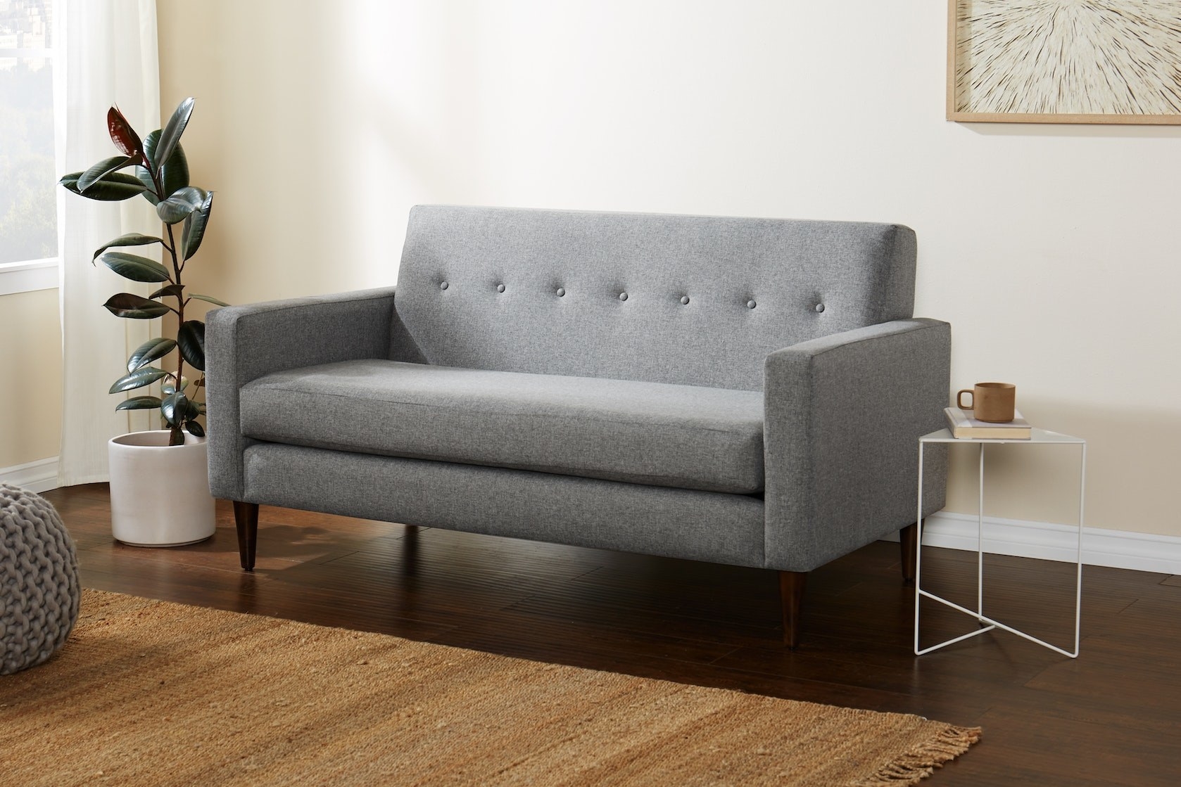A small sofa is shown in a living room