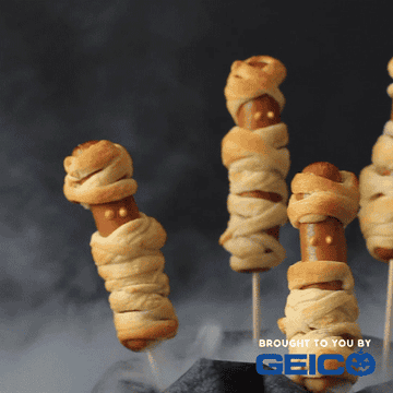 Hot dogs on a stick wrapped in crescent rolls that look like mummies